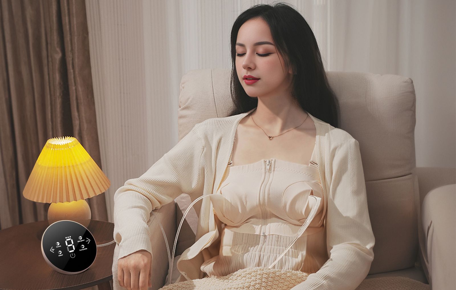 Mother resting in an armchair by lamplight while pumping